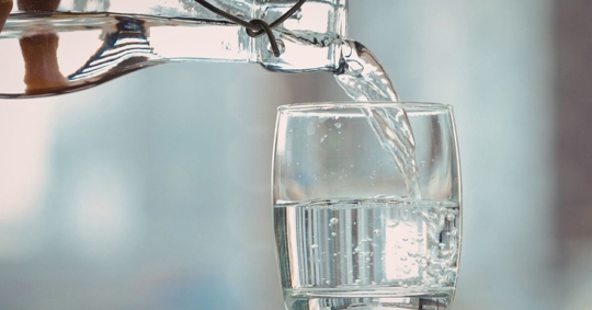 Pouring water into a glass