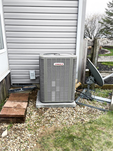 Technician evaluating whether an older HVAC system should be repaired